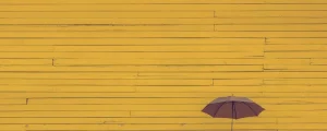 傘の背景に黄色の壁